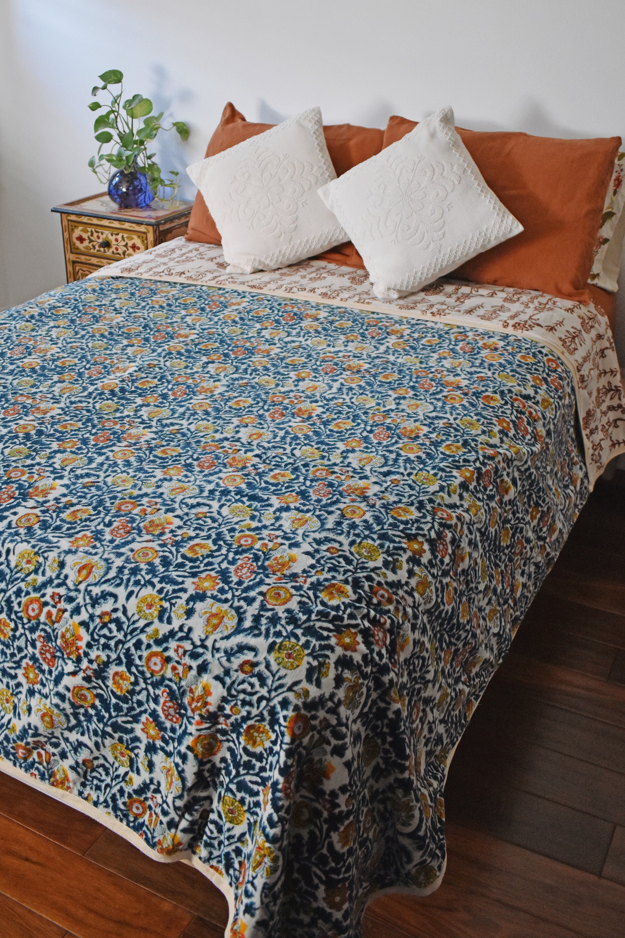 Winter Wonderland Reversible Velvet Blanket draping a full size bed, back print