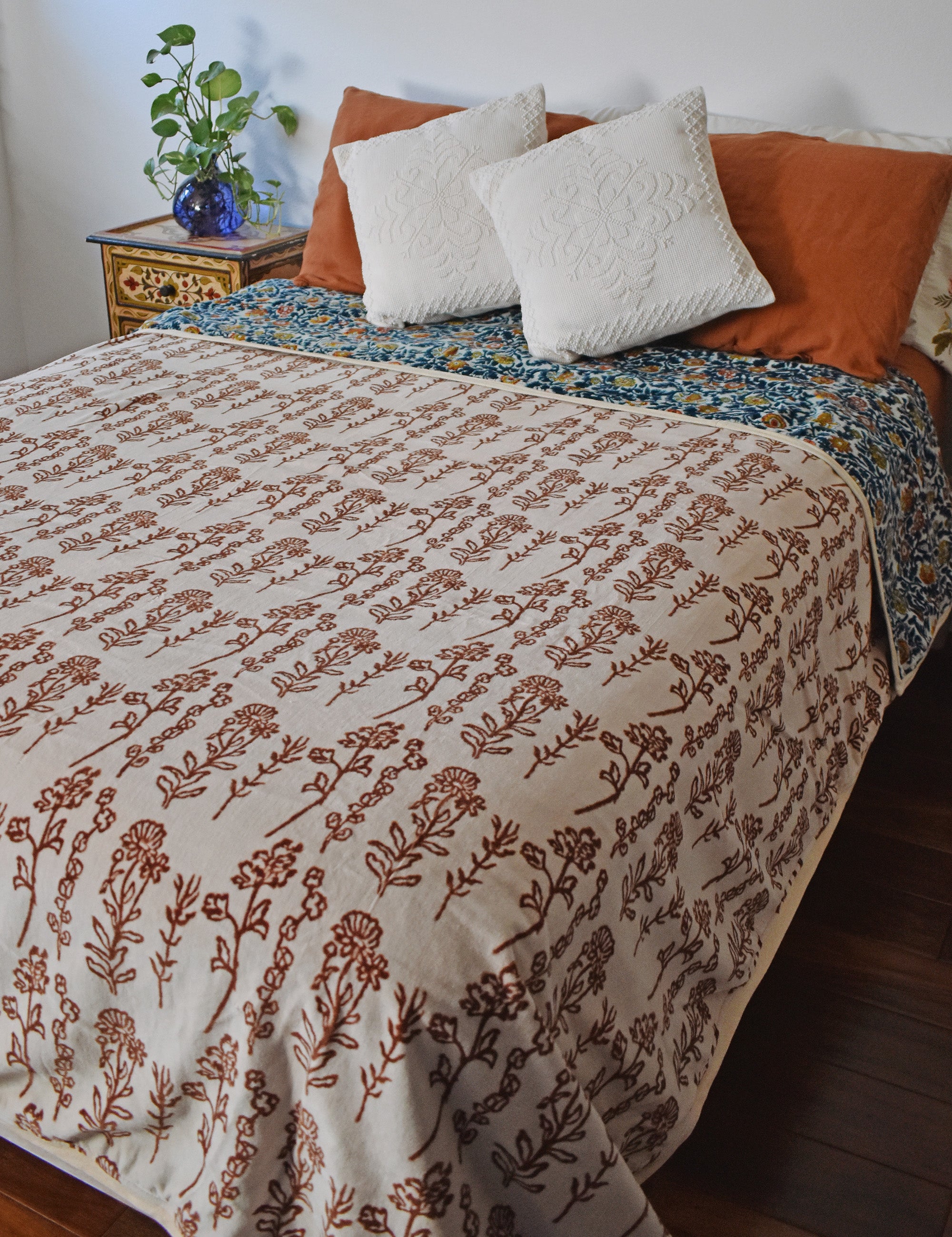 Winter Wonderland Reversible Velvet Blanket draping a full size bed, front print
