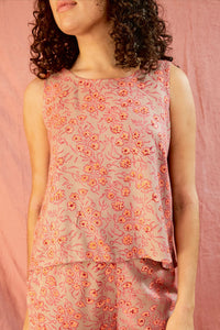 Model wearing Birkin top and pant against a pink background