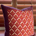 Pitaya block print pillow on a wooden desk, angled
