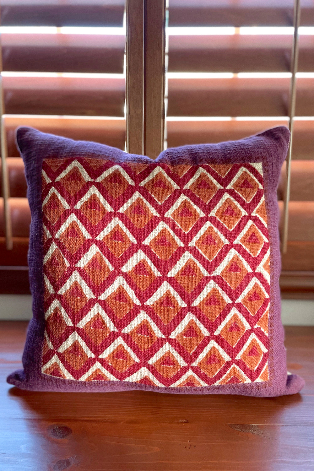 Pitaya block print pillow on a wooden desk