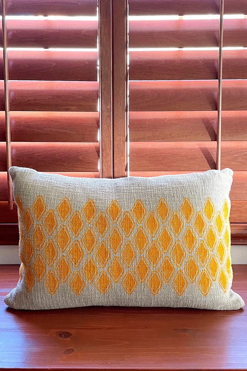 Sol Block Print Pillow on a wooden table